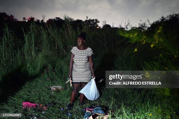 Woman looks on before she attempts to cross the Rio Grande river into the US from Matamoros, state of Tamaulipas, Mexico on May 9, 2023. The US on...