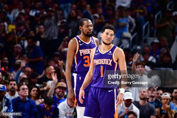 Kevin Durant of the Phoenix Suns and Devin Booker look on during Game Five of the Western Conference Semi-Finals of the 2023 NBA Playoffs against the...