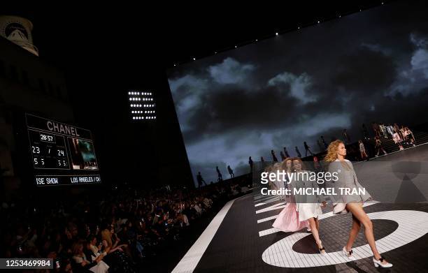 Models present designs for Los Angeles CHANEL Cruise 2023/24 show at Paramount Studios in Los Angeles, California on May 9, 2023.