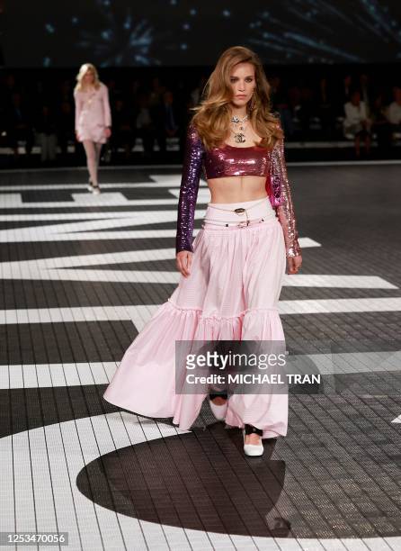 Models present designs for Los Angeles CHANEL Cruise 2023/24 show at Paramount Studios in Los Angeles, California on May 9, 2023.