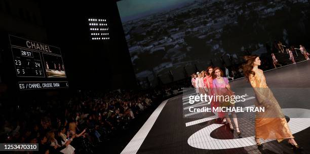 Models present designs for Los Angeles CHANEL Cruise 2023/24 show at Paramount Studios in Los Angeles, California on May 9, 2023.