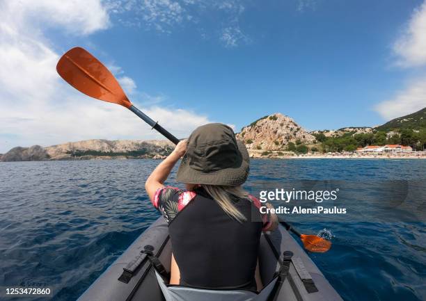 young woman sea kayaking in the ocean, back view, gopro. - coronavirus croatia stock pictures, royalty-free photos & images