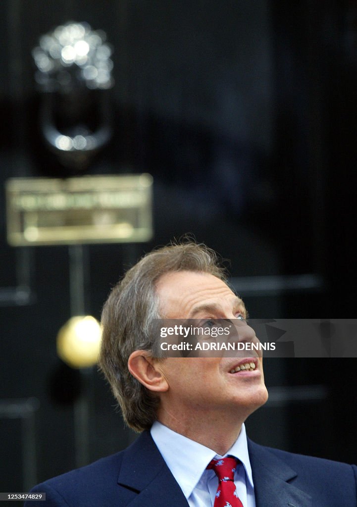 British Prime Minister Tony Blair looks up as he returns to No. 10