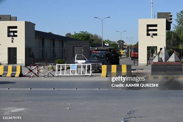 Policemen stand guard at the main entrance of the Pakistan's army headquaters, a day after protests by Pakistan Tehreek-e-Insaf party activists and...