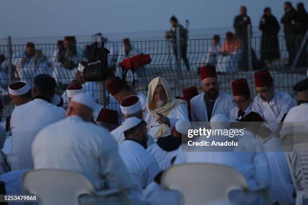 Samaritan Jews celebrate Shavuot Festival before sunrise, wearing white clothing and red tarboosh at Mount Gerizim in Nablus, West Bank on May 10,...