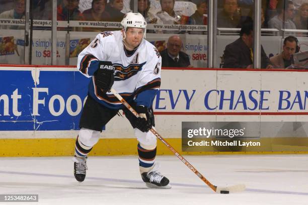 Sergie Gonchar of the Washington Capitals passes the puck during an NHL hockey game against the Phoenix Coyotes at MCI Center on January 1, 2003 in...