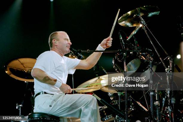 Phil Collins drumming during a performance on stage circa 1995