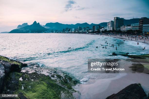 the two brother mountain and ipanema beach at night view from arpoador rock in rio de janeiro - arpoador beach stock pictures, royalty-free photos & images