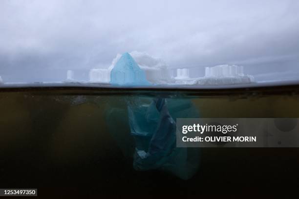 This illustration picture shows a plastic bag drifting in the botnia Gulf on May 3, 2023 near Pietarsaari, during the late spring as the sea-ice is...