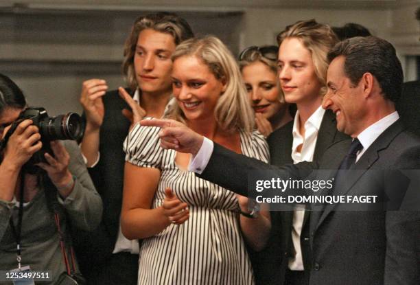 French right-wing presidential candidate of the Union for a Popular Movement Nicolas Sarkozy is applauded by his children as he arrives to deliver a...