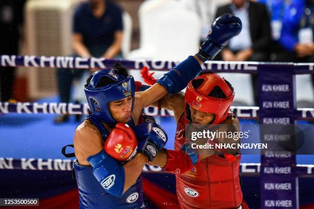 Cambodia's Koemrieng Him and Laos' Soukna Keothatalath compete in the men's 54kg kun khmer fight during the 32nd Southeast Asian Games in Phnom Penh...