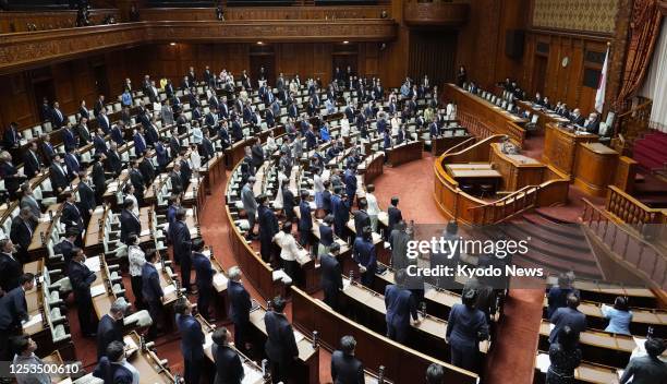 The House of Councillors passes at a plenary session in Tokyo on May 10 a bill permitting courts to approve the placing of GPS monitors on suspects...