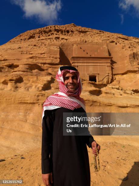 Saudi tourist in front of a Nabataean tomb in al-Hijr archaeological site in Madain Saleh, Al Madinah Province, Alula, Saudi Arabia on January 23,...
