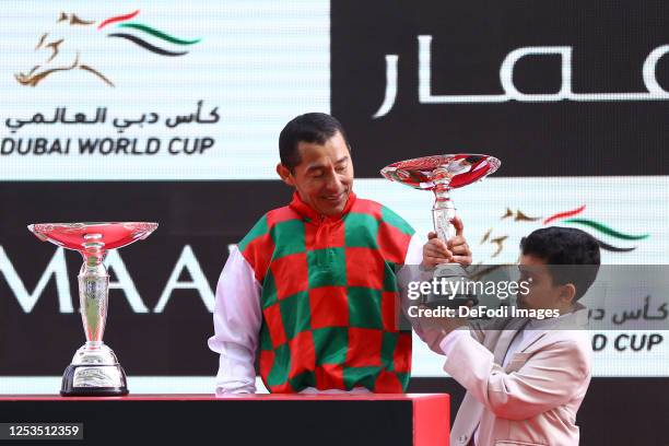 Oscar Chavez raise the trophy of the Dubai Kahayla Classic track during the Dubai World Cup at Meydan Racecourse on March 25, 2023 in Dubai, United...