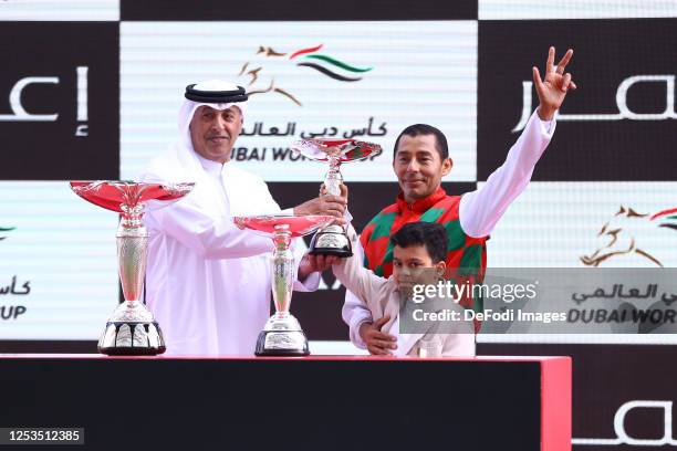 Oscar Chavez raise the trophy of the Dubai Kahayla Classic track during the Dubai World Cup at Meydan Racecourse on March 25, 2023 in Dubai, United...