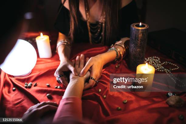 fortune teller reading from palm - fortune teller stock pictures, royalty-free photos & images