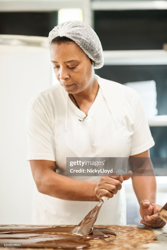 Chocolatier mixing melted chocolate