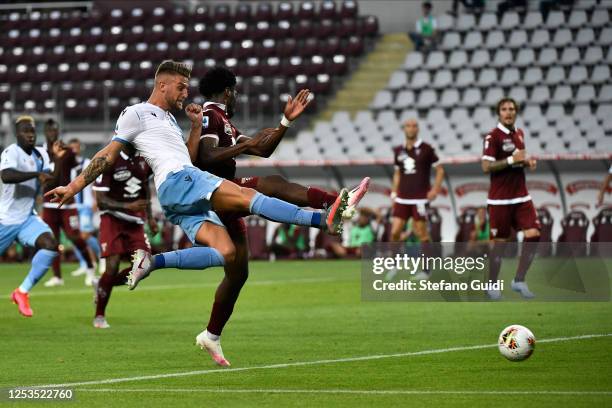 Sergej Milinković-Savić of SS Lazio kicks the ball against Ola Aina of Torino during the Serie A match between Torino FC and SS Lazio at Stadio...