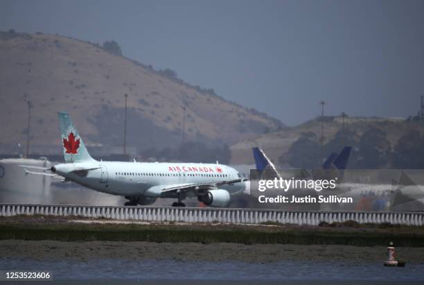 An Air Canada Airbus A320 prepares to take off from San Francisco International Airport to Toronto on June 30, 2020 in San Francisco, California....