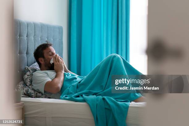 sick man with covid-19 symptoms in bed - thermometer turkey stock pictures, royalty-free photos & images