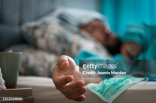 Hand of sick man in bed