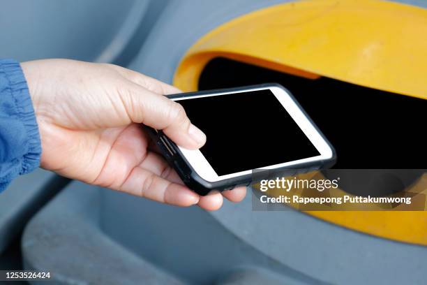 woman throwing a phone into the trash - throwing phone stock pictures, royalty-free photos & images