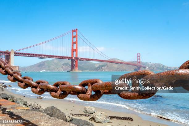Golden Gate Bridge viewed with rusted chain in foreground, San Francisco, California, June 28, 2020.