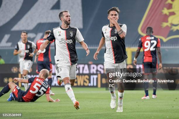 Juventus player Paulo Dybala celebrates after scoring the 0-1 goal with Miralem Pjanic during the Serie A match between Genoa CFC and Juventus at...