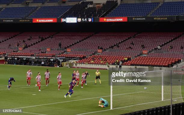 Lionel Messi of FC Barcelona scores his team's second goal and his 700th career goal by penalty against Goalkeeper Jan Oblak of Atletico Madrid...