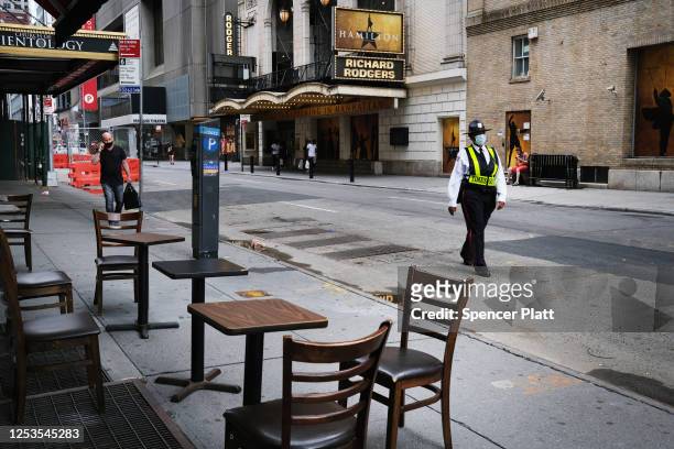 Broadway theaters stand closed along an empty street in the theater district on June 30, 2020 in New York City. The Broadway League, a trade...