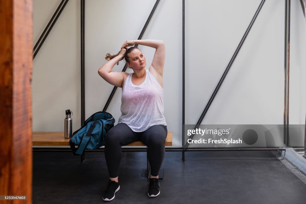 Beautiful Plus Size Woman Getting Ready for her Workout - Tying her Hair