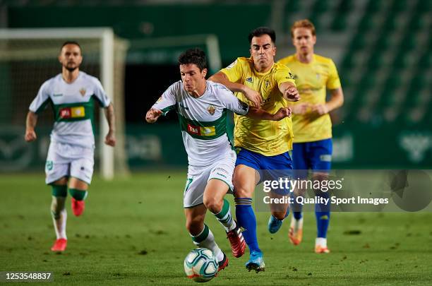 Jony Alamo of Elche CF competes for the ball with Jose Manuel Jurado Marin of Cadiz CF during the La Liga Smartbank match between Elche CF and Cadiz...