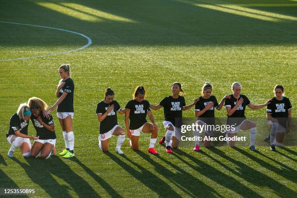 Julie Ertz and Rachel Hill console Casey Short of the Chicago Red Stars as teammates kneel during the national anthem before a game against the...