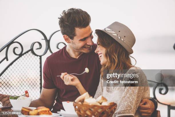 affectionate couple during dinner - valentines headwear stock pictures, royalty-free photos & images