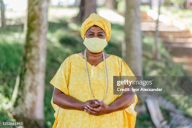 covid-19: portrait of a brazilian religious woman in the public park - voodoo experience day 1 stock pictures, royalty-free photos & images