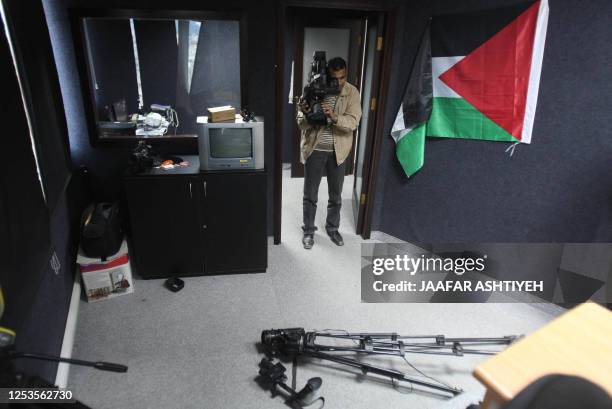 Correcting information in the caption A press cameraman films damages at a studio at the Palestinian media centre in the West Bank city of Nablus...
