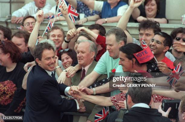 Britain's new Prime Minister and Labour leader Tony Blair is greeted by supporters outside 10 Downing Street when he arrives, 02 May 1997, after...