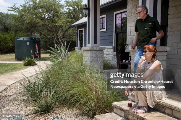 Max and Paula Fowler are out on their front porch near their now required new water tank on Monday, May 11, 2020 in Blanco, Texas. After crews...