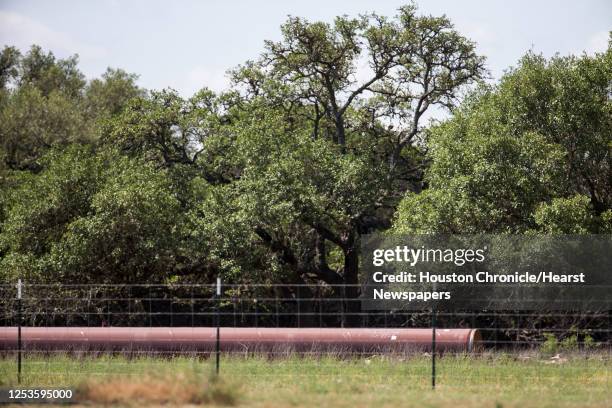 Pipeline is laid out on the ground within yards from Katherine McClure's water well on Monday, May 11, 2020 in Blanco, Texas. After crews working for...