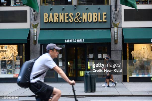 People walk outside the Barnes & Noble book store on Fifth Avenue as New York City moves into Phase 2 of re-opening following restrictions imposed to...