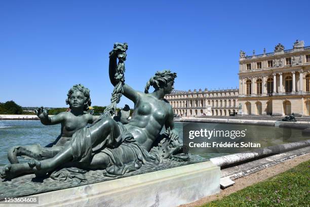 Water basin called Parterre d'eau with the palace of Versailles in the background, île de France, on June 23, 2020 in Paris, France.