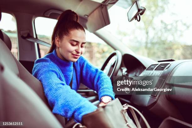 female searching her handbag before going on a trip - purse contents stock pictures, royalty-free photos & images