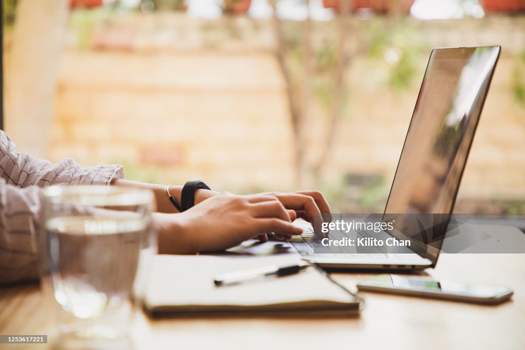Asian woman using a laptop at home