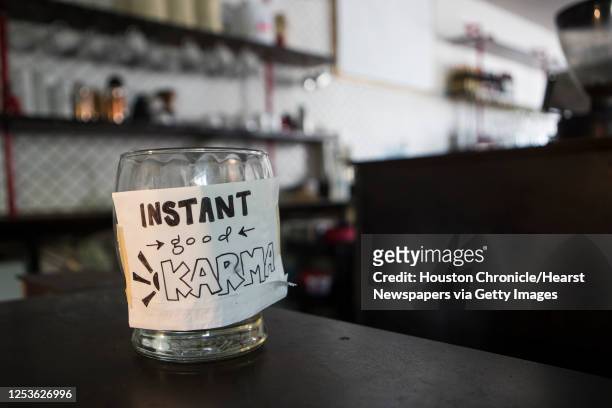 Tip jar sits on the counter at Cafeza Tuesday, Sept. 1, 2020 in Houston. The coffee shop, known also as a live music venue, is closed down for...