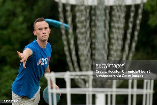 Shea Cain takes a shot while playing a round of disc golf during the Thursday night league of the Houston Flying Disc Society on Thursday, Sept. 3,...
