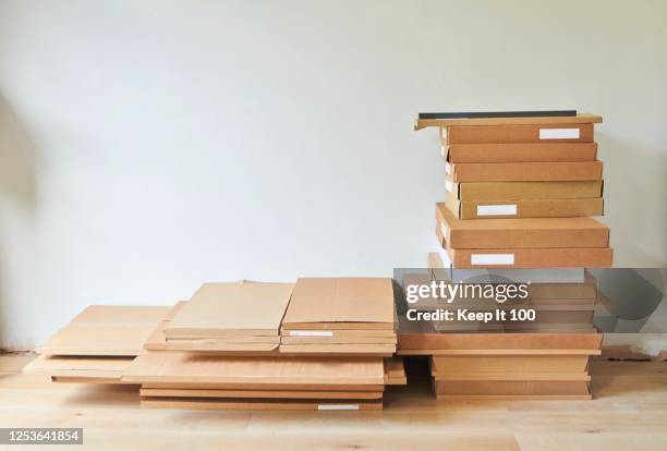 still life of a pile of boxes in a domestic room. - ikea stock pictures, royalty-free photos & images