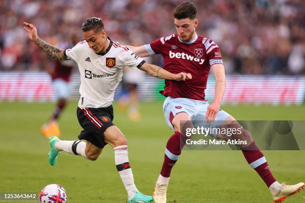 Declan Rice of West Ham in action with Antony of Manchester United during the Premier League match between West Ham United and Manchester United at...