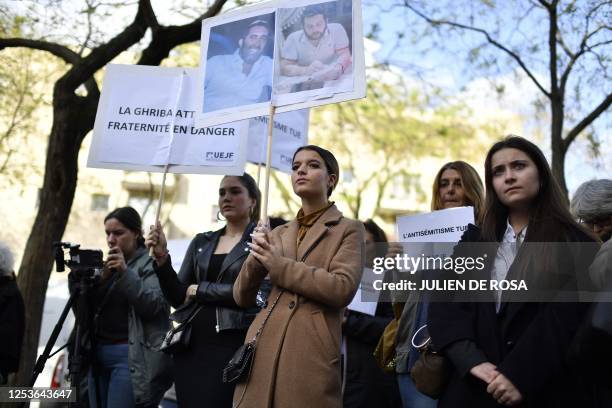 People hold placards reading "anti-semitism kills" during a rally for the victims and against anti-semitism after a bloody shooting rampage in which...