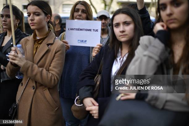Woman holds a placard reading "anti-semitism kills" during a rally for the victims and against anti-semitism after a bloody shooting rampage in which...