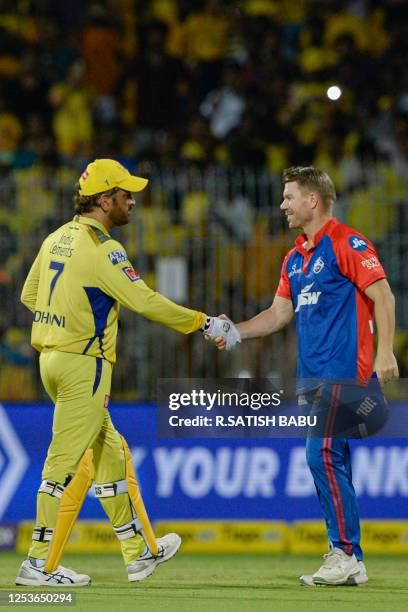 Chennai Super Kings' Mahendra Singh Dhoni shakes hands with Delhi Capitals' David Warner at the end of the Indian Premier League Twenty20 cricket...